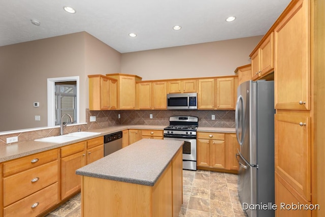 kitchen featuring a center island, light brown cabinets, sink, decorative backsplash, and stainless steel appliances