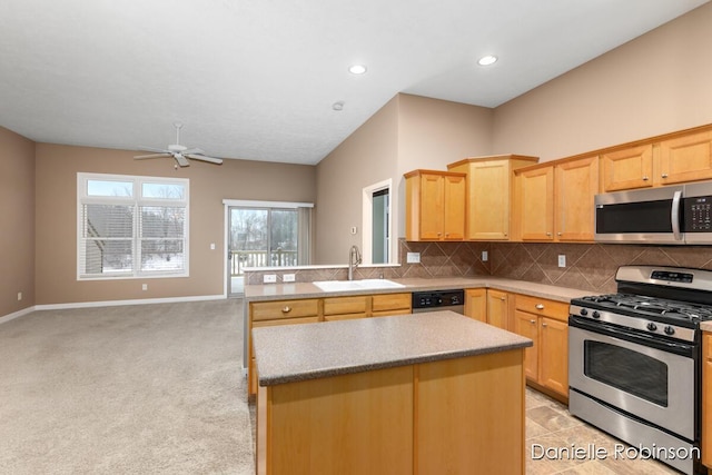 kitchen featuring light brown cabinets, light carpet, sink, appliances with stainless steel finishes, and tasteful backsplash