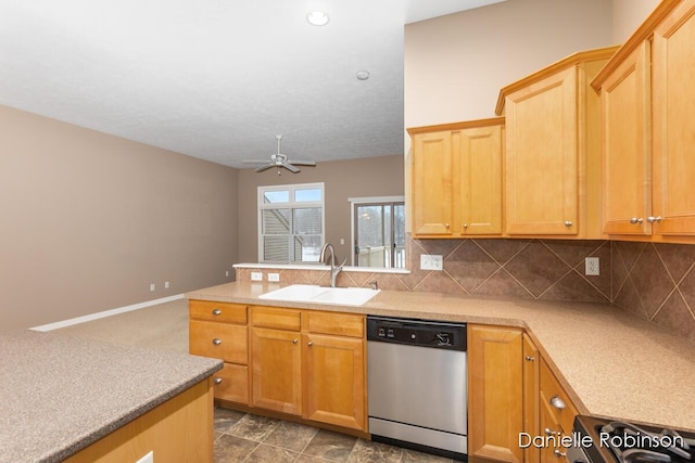 kitchen with stove, tasteful backsplash, ceiling fan, sink, and dishwasher