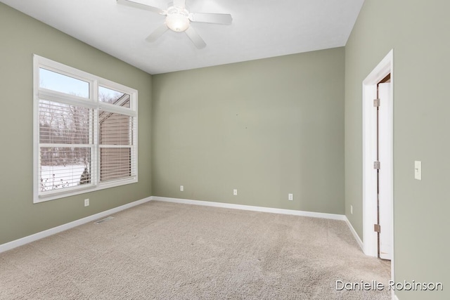 spare room with carpet and ceiling fan