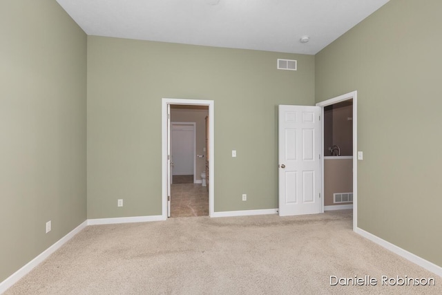 unfurnished bedroom with light carpet