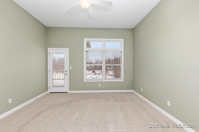 carpeted empty room featuring ceiling fan