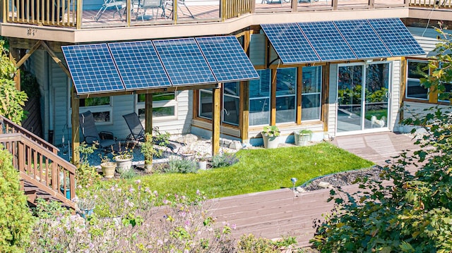 rear view of property with solar panels