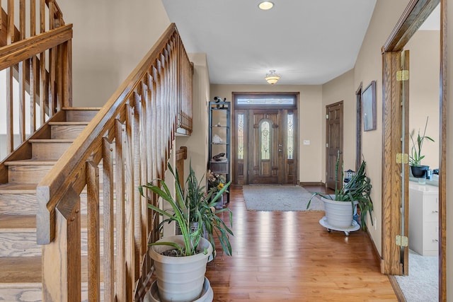 foyer featuring stairway, recessed lighting, light wood finished floors, and baseboards