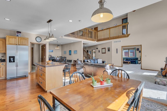 dining space featuring visible vents, recessed lighting, stairs, light wood finished floors, and baseboards