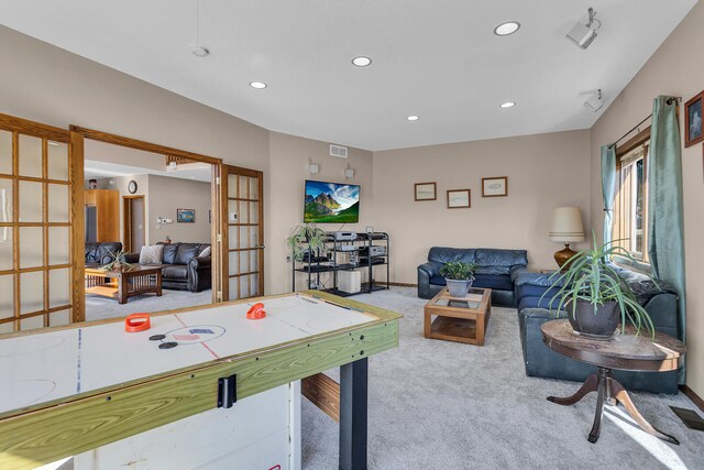 recreation room with light carpet and french doors