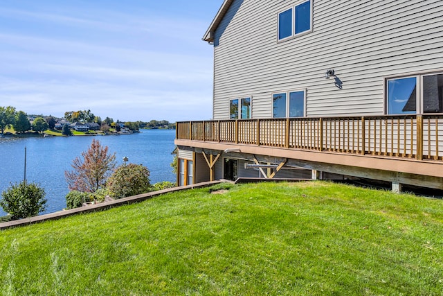 dock area with a lawn and a deck with water view