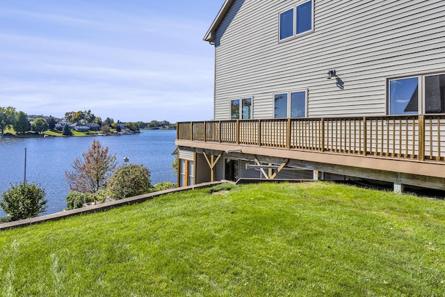 dock area with a deck with water view and a yard