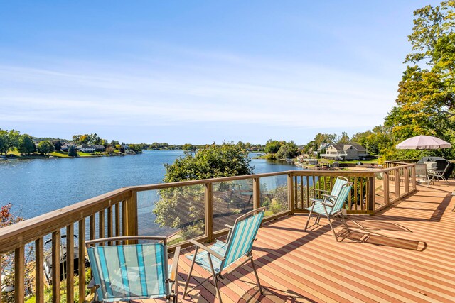 wooden terrace featuring a water view