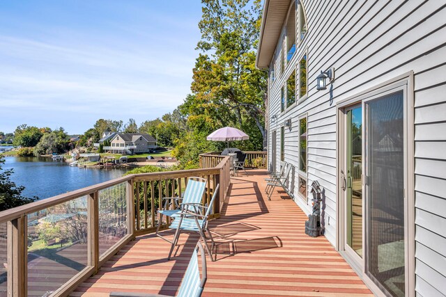 wooden deck featuring a water view