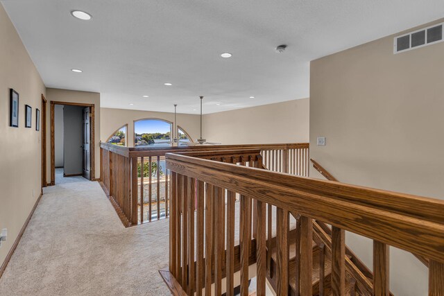 corridor with light colored carpet