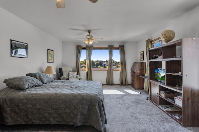 bedroom with light carpet, a textured ceiling, and ceiling fan