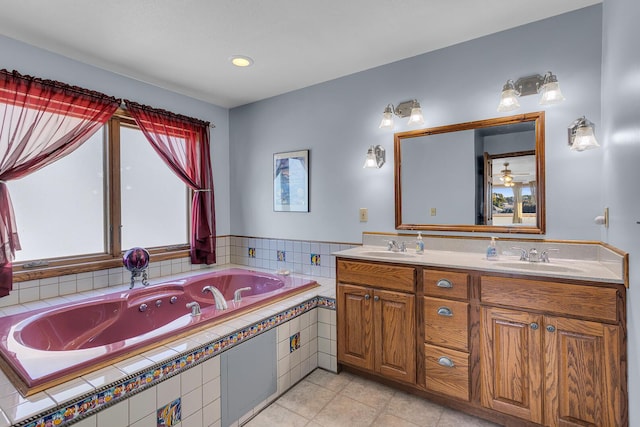 bathroom with tile patterned floors, a sink, double vanity, and a jetted tub