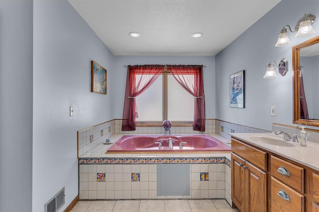full bath with visible vents, vanity, tile patterned flooring, and a garden tub