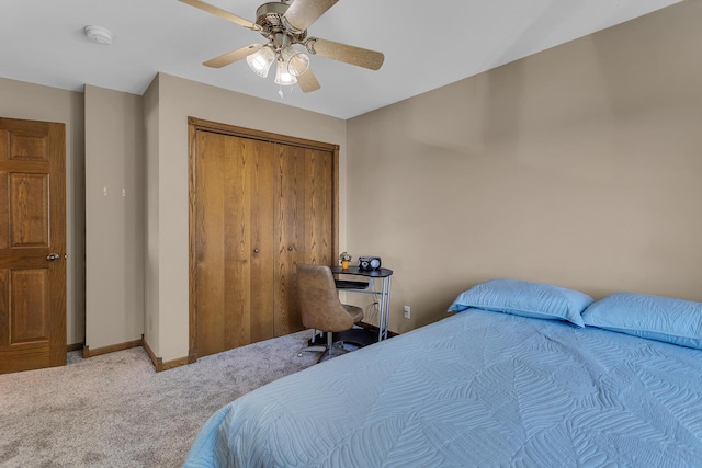 carpeted bedroom featuring a closet, ceiling fan, and baseboards