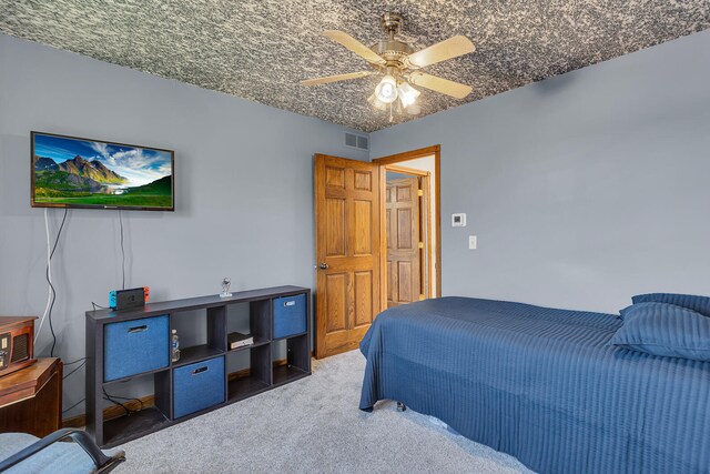 bedroom with ceiling fan and dark carpet