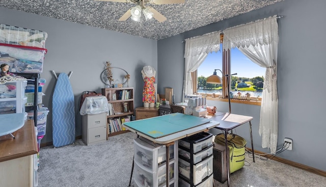 rec room featuring carpet floors, baseboards, and ceiling fan