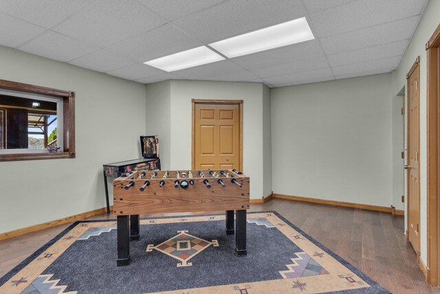 playroom featuring hardwood / wood-style flooring and a paneled ceiling