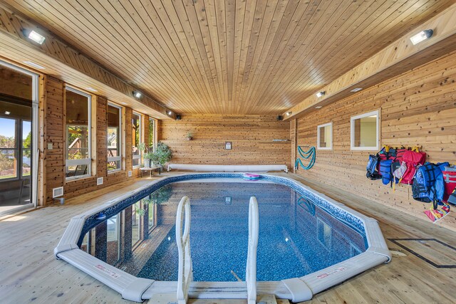 view of swimming pool with a hot tub