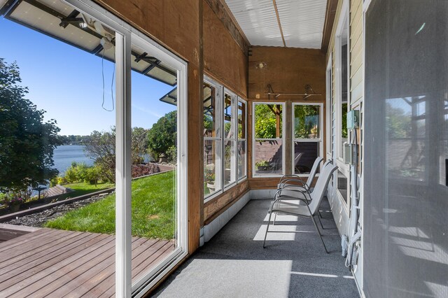 unfurnished sunroom with a water view and a wealth of natural light