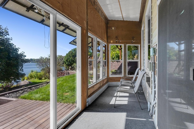 unfurnished sunroom featuring a water view