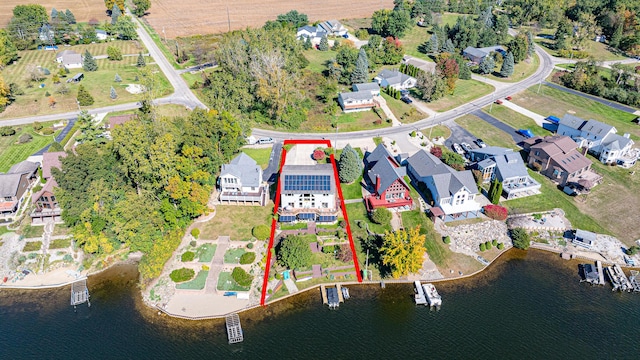 drone / aerial view with a water view and a residential view