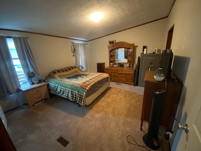 bedroom featuring a textured ceiling, crown molding, and carpet flooring