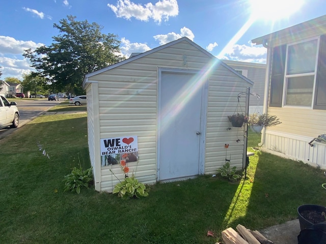 view of outbuilding featuring a yard