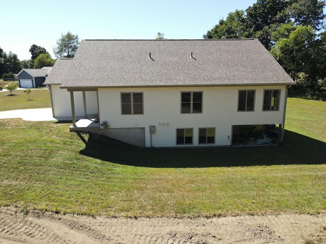 rear view of property featuring a yard