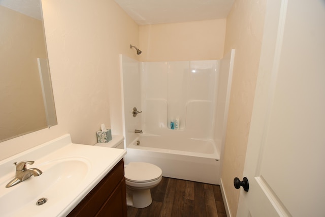 full bathroom featuring wood-type flooring, shower / bathtub combination, vanity, and toilet