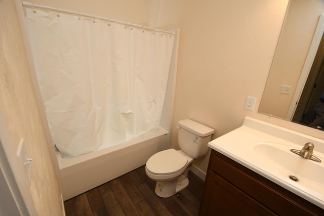 full bathroom with hardwood / wood-style floors, vanity, toilet, and shower / bath combo with shower curtain