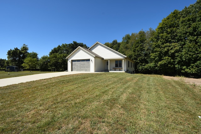 view of front of house with a garage and a front lawn