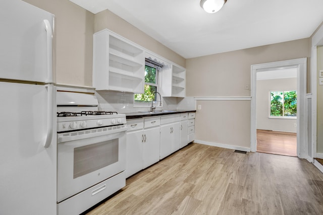 kitchen featuring light hardwood / wood-style floors, white appliances, sink, decorative backsplash, and white cabinets