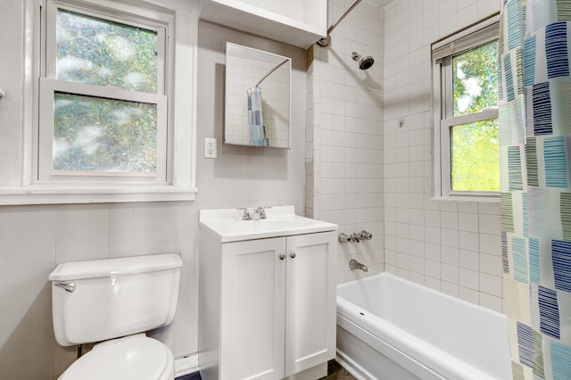 full bathroom featuring a healthy amount of sunlight, vanity, toilet, and shower / bathtub combination with curtain