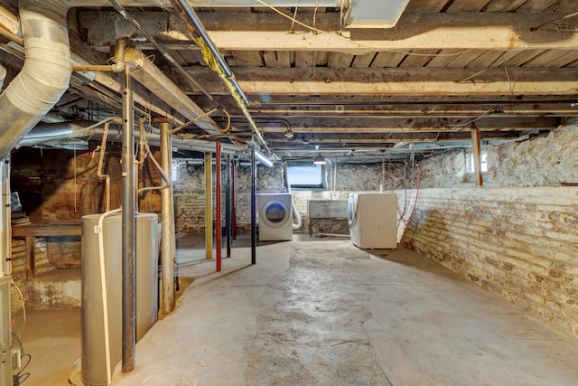 basement featuring independent washer and dryer and water heater