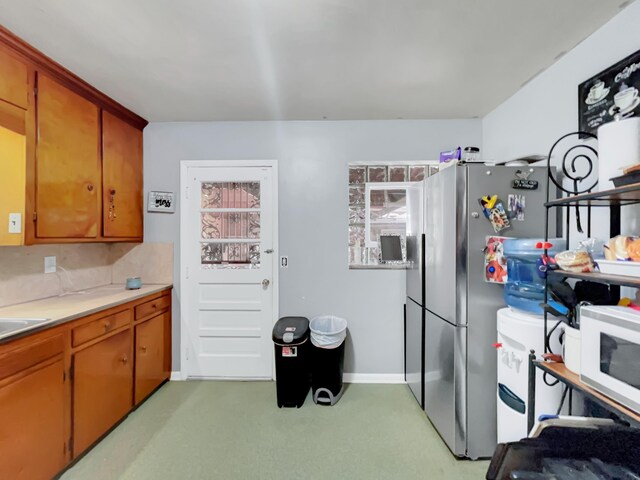 kitchen featuring stainless steel fridge with ice dispenser