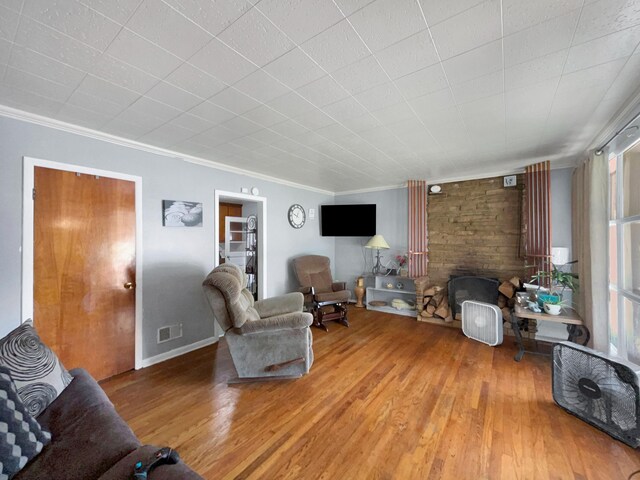 living room featuring wood-type flooring and crown molding