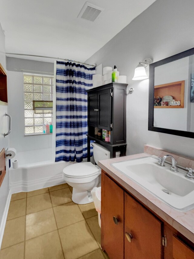 full bathroom with shower / tub combo with curtain, tile patterned floors, vanity, and toilet