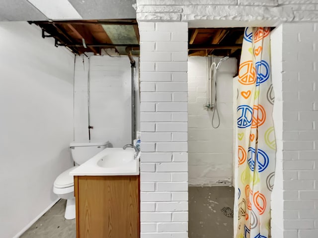 bathroom with concrete floors, curtained shower, vanity, and toilet