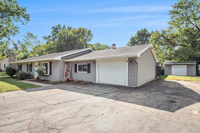 ranch-style house featuring a shed and a garage