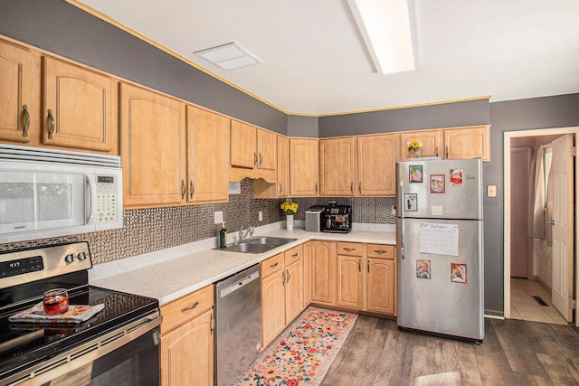 kitchen featuring light brown cabinets, backsplash, sink, dark hardwood / wood-style floors, and appliances with stainless steel finishes