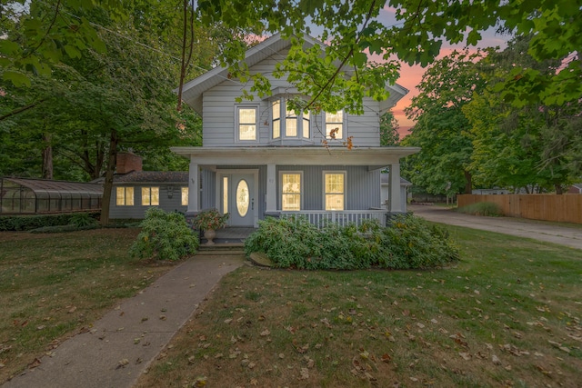 view of front of home featuring a porch and a lawn