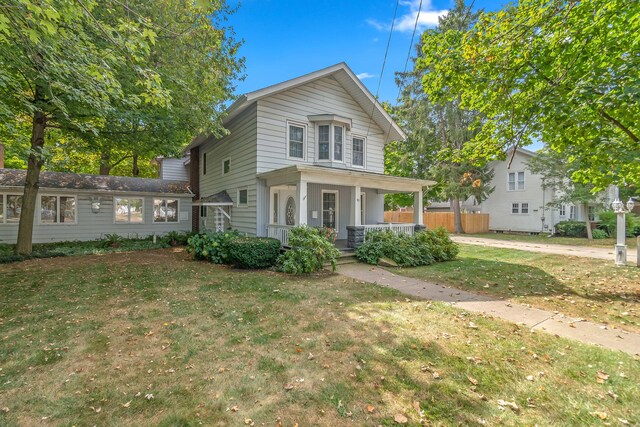 front facade featuring a porch and a front lawn