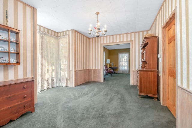 interior space featuring a notable chandelier and dark carpet