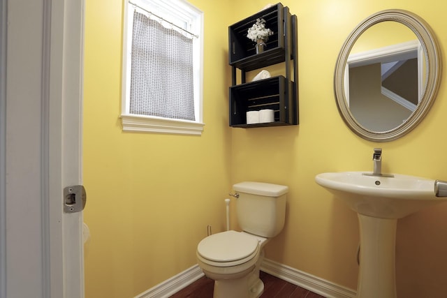 bathroom featuring hardwood / wood-style flooring and toilet