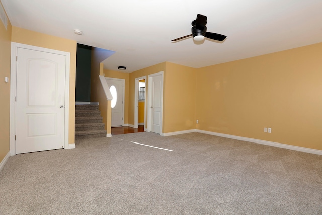 carpeted spare room featuring ceiling fan