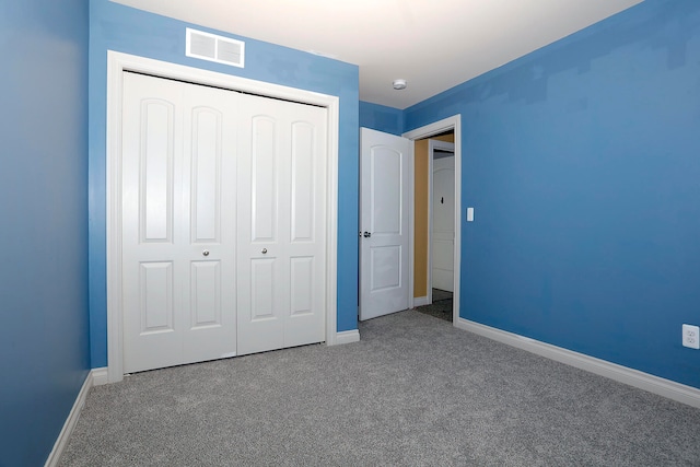 unfurnished bedroom featuring carpet and a closet