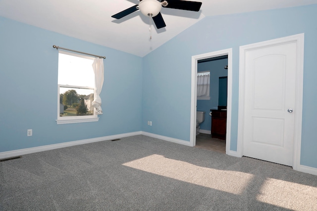 carpeted spare room featuring lofted ceiling and ceiling fan