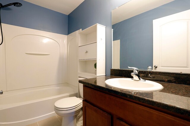 full bathroom featuring tile patterned floors, washtub / shower combination, vanity, and toilet