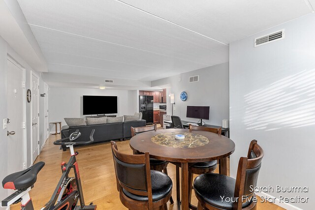 dining space featuring light wood-type flooring